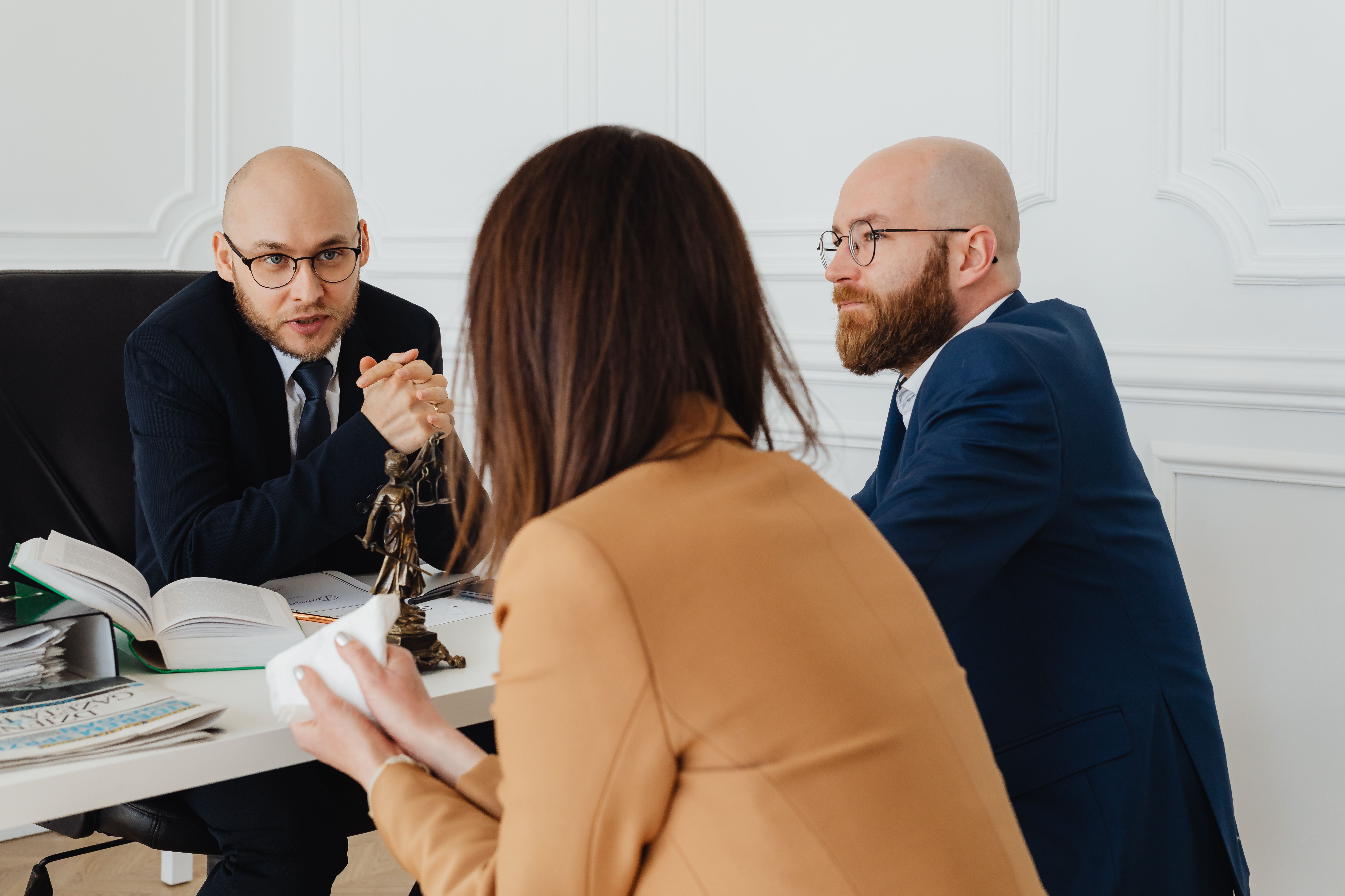 Lawyers discussing legal matters in a modern office, showing collaboration and professional practice.