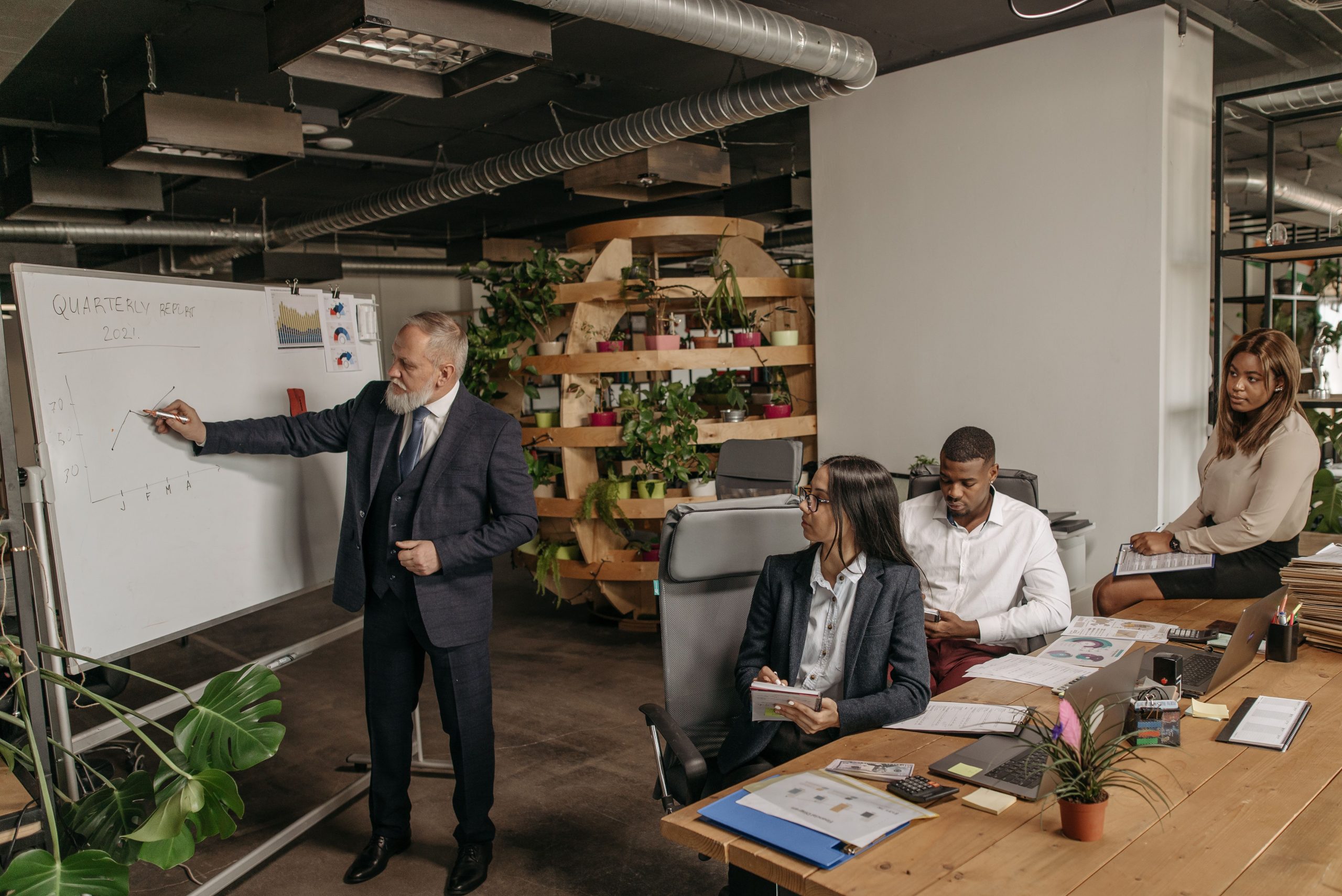 Why Organizational Accountability Matters for Long-Term Stability A diverse business team reviewing quarterly results and discussing shared organizational responsibilities during a presentation.