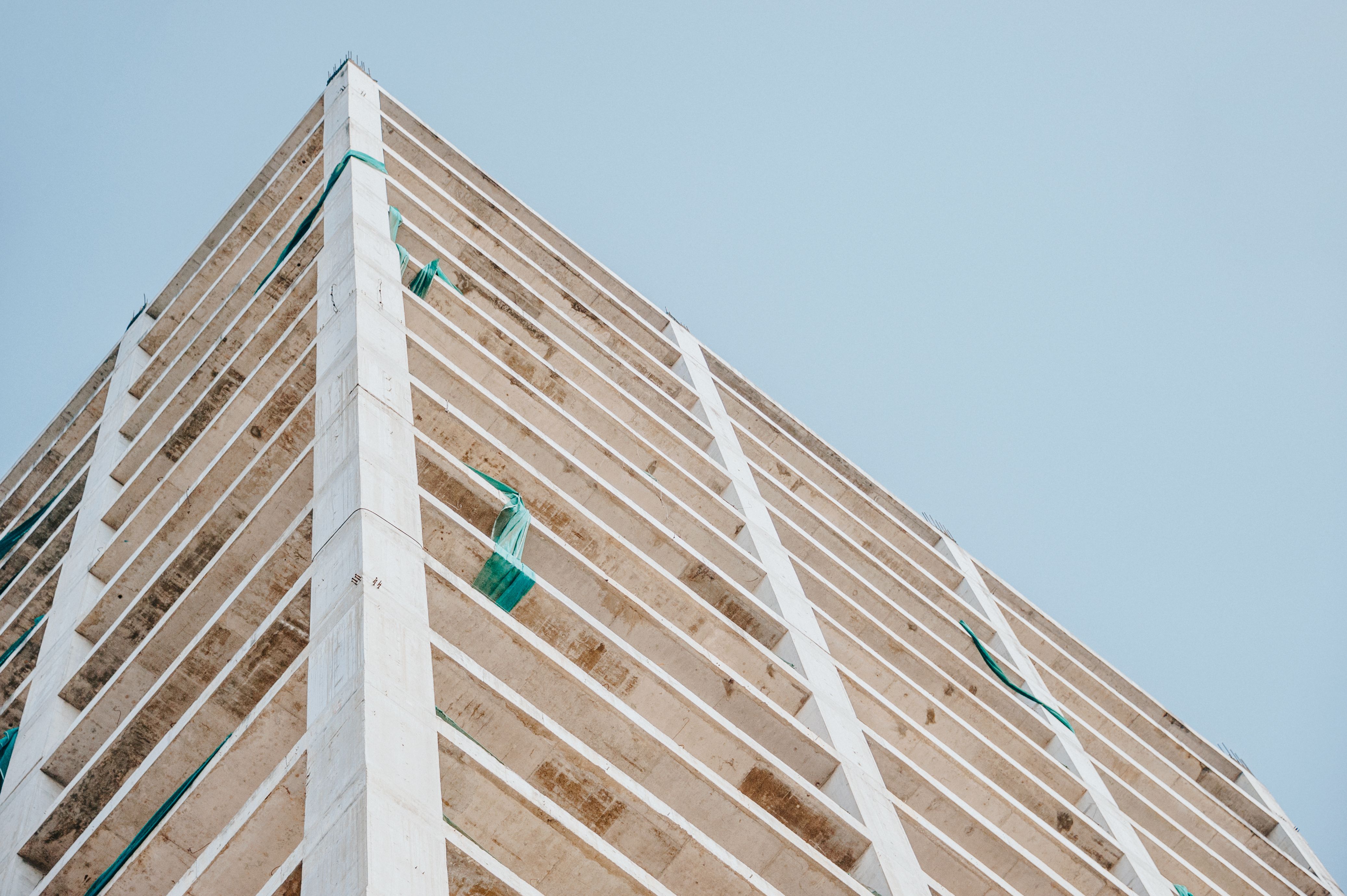 A sturdy modern building under construction symbolizing the strong foundation needed for long-term organizational stability.